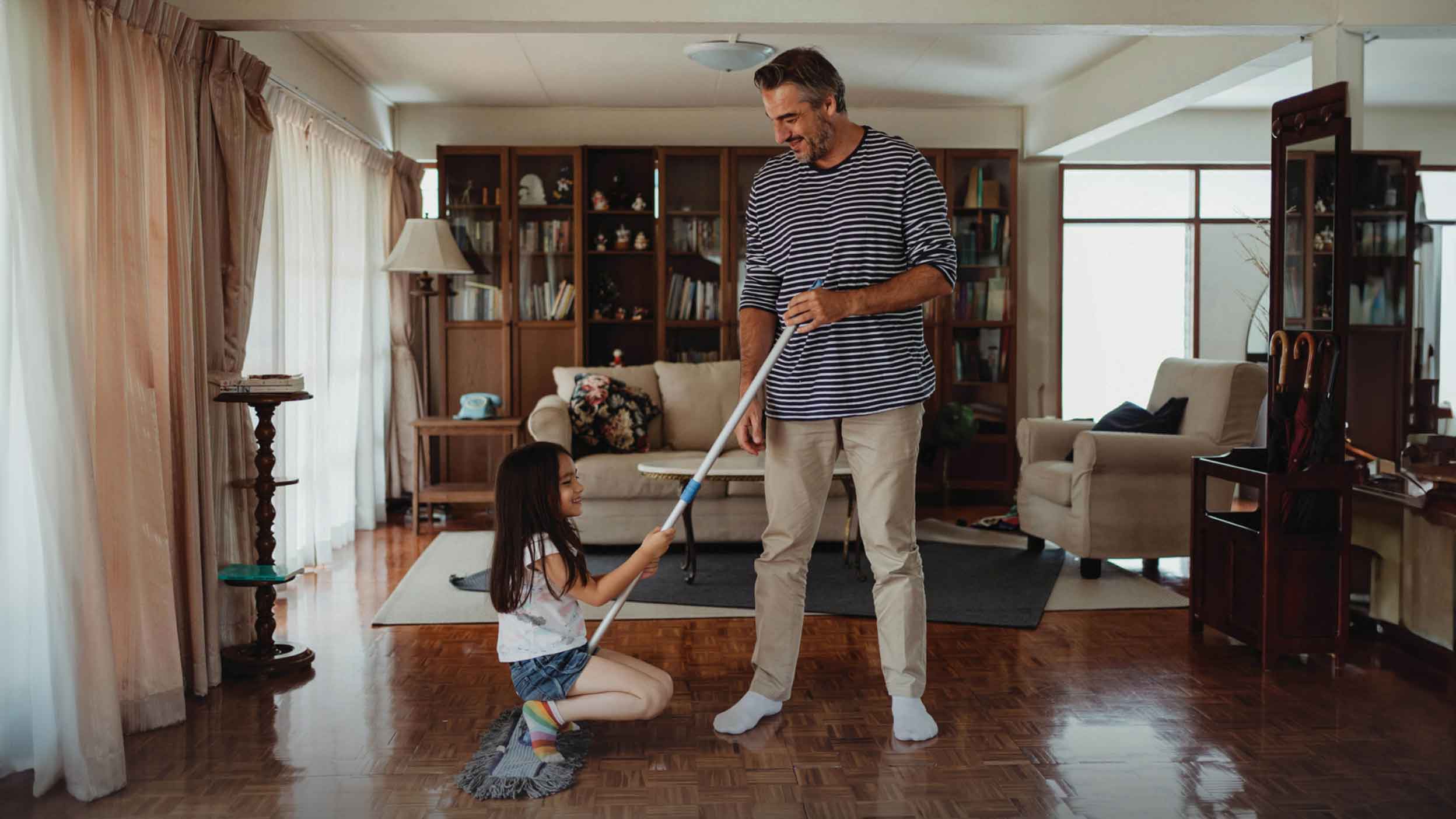 A father and daughter cleaning their house for better air quality